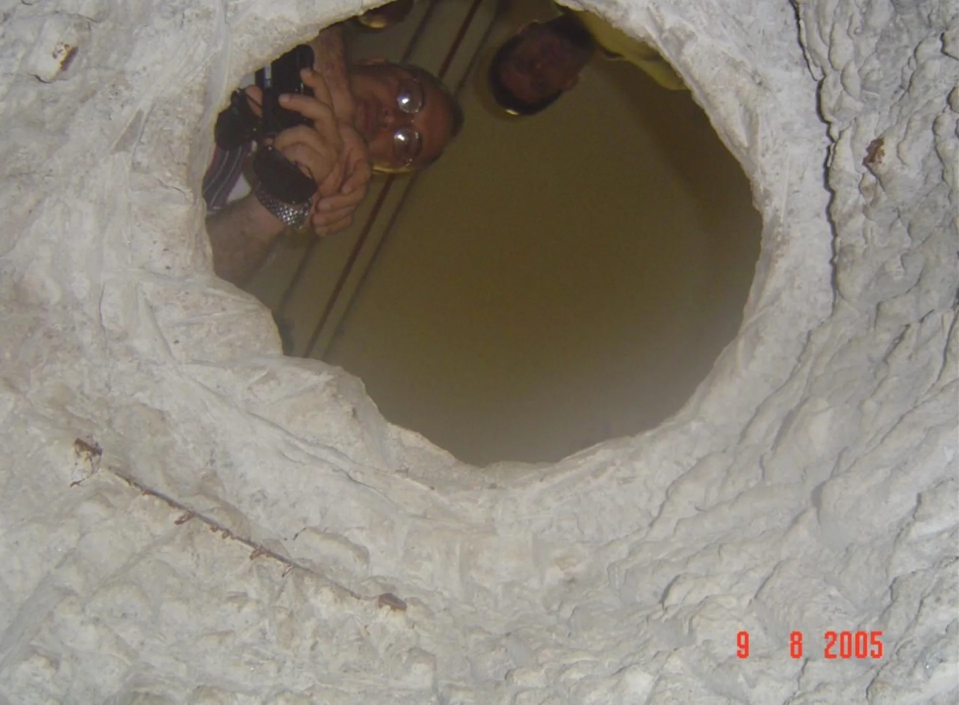 Federal Police investigator Antônio Celso dos Santos photographs the tunnel
