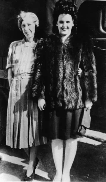 American aspiring actress and murder victim Elizabeth Short , known as the 'Black Dahlia,' wears a fur coat and stands with her mother, Phoebe Mae...