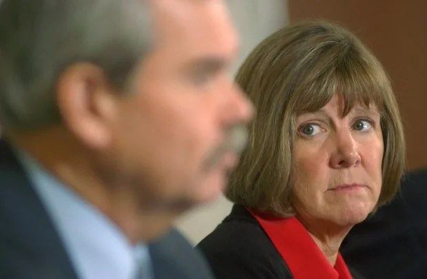 Boulder County District Attorney Mary Lacy, left, looks at investigator...