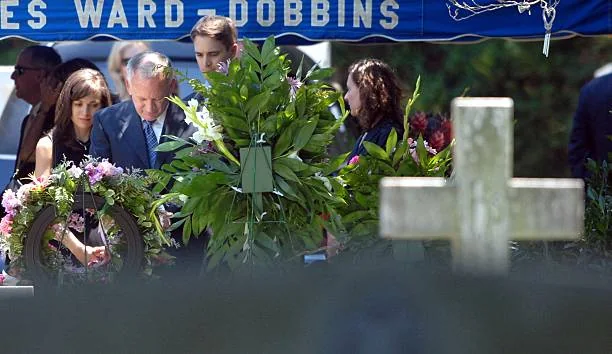 John Ramsey stands over the graves of his daughters Elizabeth and JonBenet after the graveside service for his wife Patsy Ramsey June 29, 2006 in...